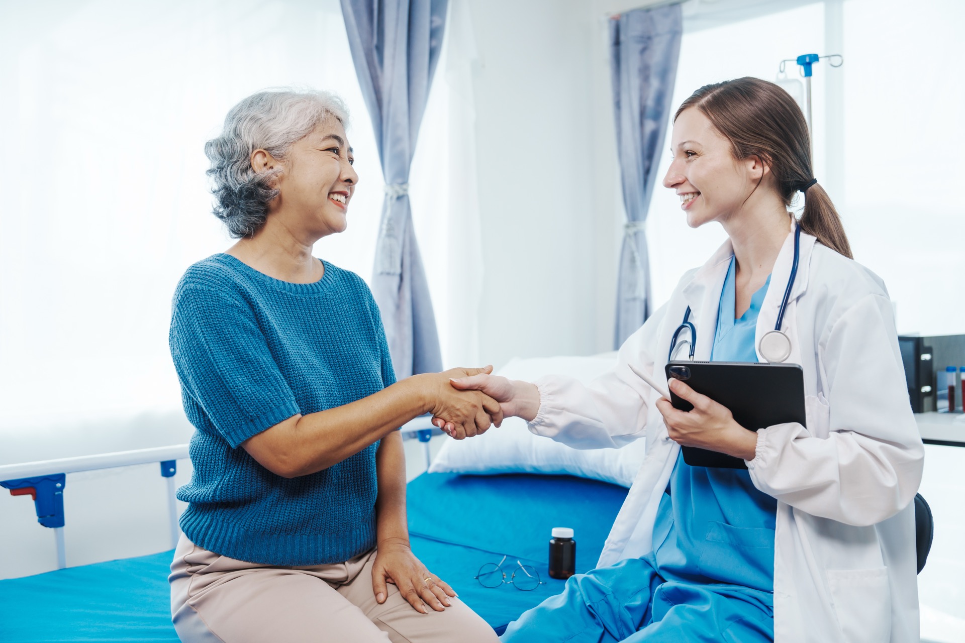 Doctor shaking hands with a colleague during practice handover