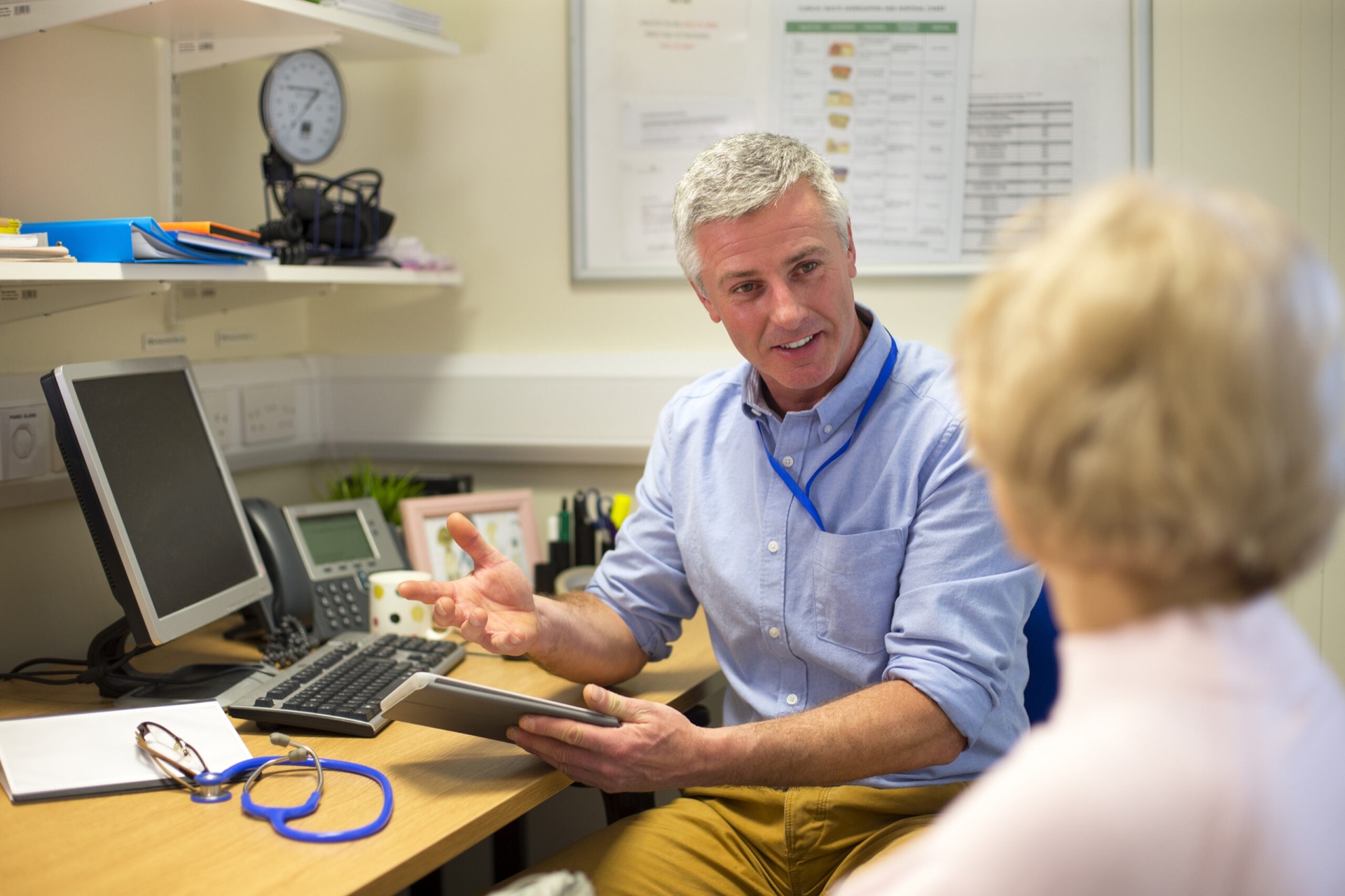 GP consulting with a patient in a familiar practice setting